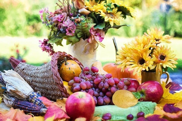 A photo of flowers and fruits for thanksgiving