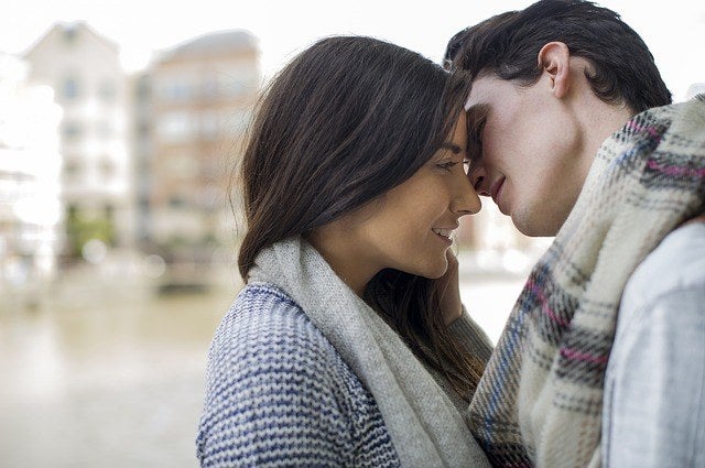 A man kissing his girlfriend