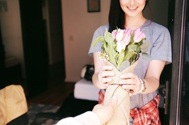 A girl receiving a bouquet of flowers