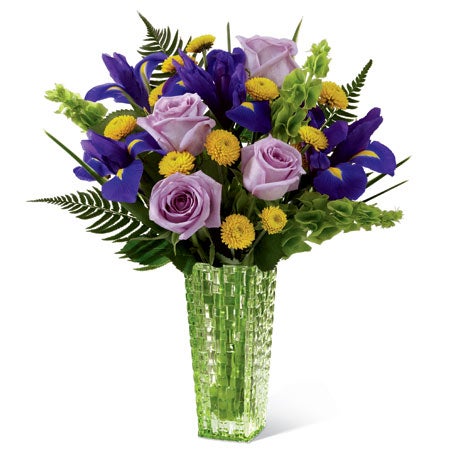 A Bouquet of  Light-Purple Roses, Irises, Canary Button Poms and Bells of Ireland in a Designer Vase