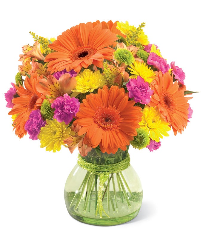  Orange gerbera daisies, yellow poms and pink carnations in green vase