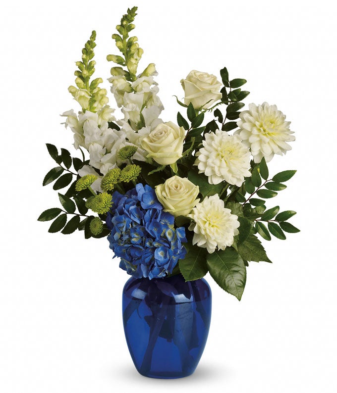 Blue Hydrangea and white flowers in a blue vase