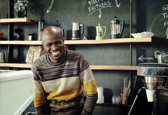 A happy man wearing a striped sweatshirt