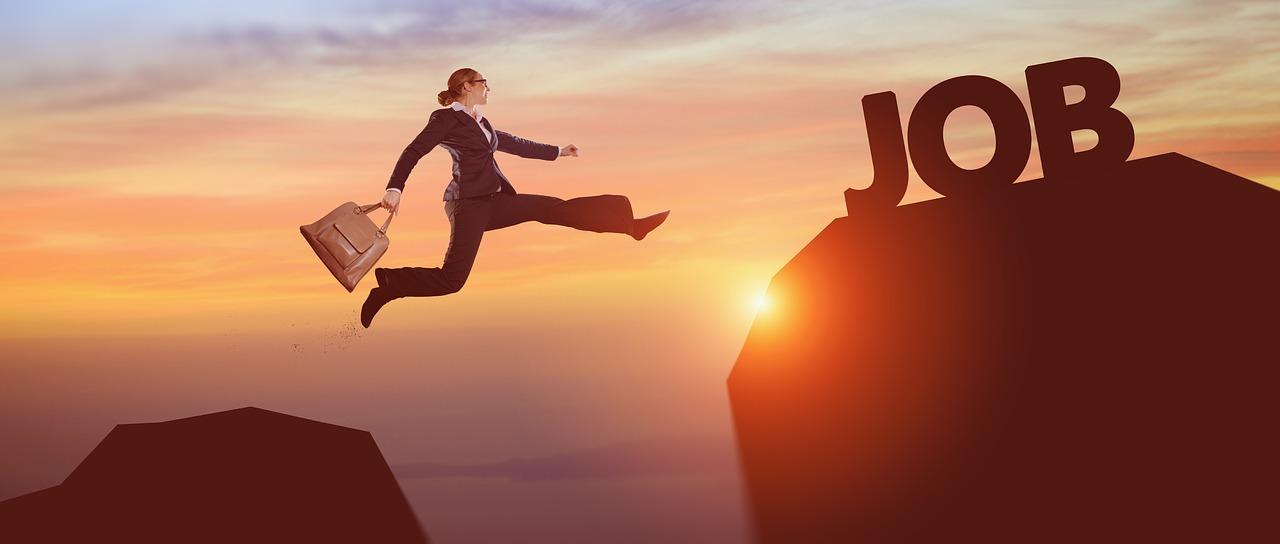 A girl on a business suit jumping on another milestone of her job