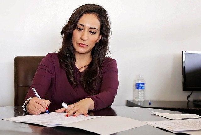 A woman writing down ideas on her notebook