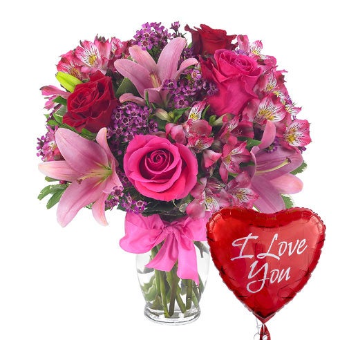 A Bouquet of Hot-Pink And Red Roses, Pink Asiatic Lilies, Blush Alstroemeria and Indigo Waxflower in a Glass Vase With Bow and One Heart-Themed Mylar Balloon