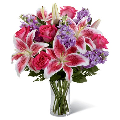 A Bouquet of Hot Pink Roses, Pink Stargazer Lilies and Light-Purple Stock in a Cylinder Vase