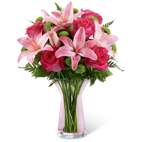 A Bouquet of Pink Asiatic Lilies, Pink Roses and Green Button Poms in a Keepsake Designer Pink Glass Vase