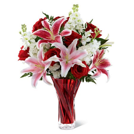 Red and pink stargazer lily bouquet with white stock flowers in red vase