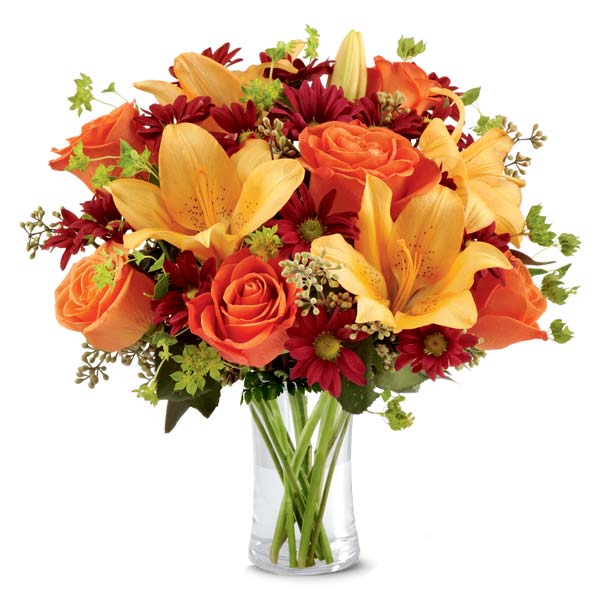 Peach lily and orange rose flower bouquet with dark brown glass vase