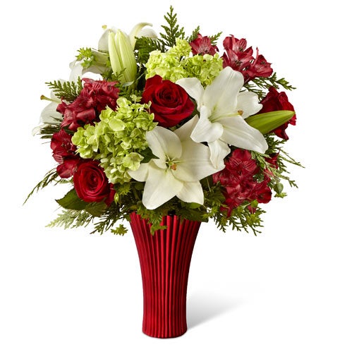 A bouquet of White Asiatic Lily, Bupleurum, Maroon Alstroemeria, Red Roses and Green Hydrangea in a Red Abstract Flower Vase