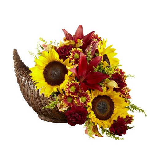A Bouquet of  Red roses, Sunflowers, Orange Asiatic lilies, Burgundy daisies, Solidago, Red glycerized oak leaves and Lush greens in a Natural cornucopia basket