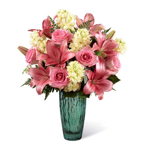 Pink lily and pink rose mixed flower bouquet with yellow stock in a sea-green vase