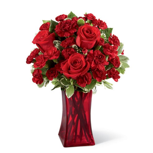 A Bouquet of  Red Roses, Burgundy Mini Carnations and Lush Greens in a Stylish Red Glass Vase