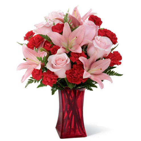Blush pink lilies and red carnations