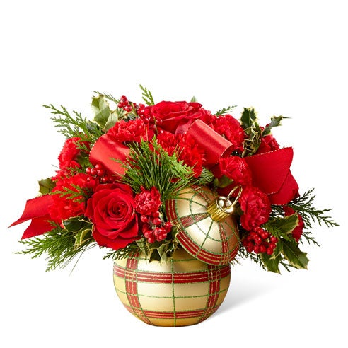 A bouquet of Red Mini Carnations, Red Carnations, Red Roses (Deluxe and Premium Sizes Only),Assorted Christmas Greens and Holly with Red Ribbon on an Ornament Vase with Lid