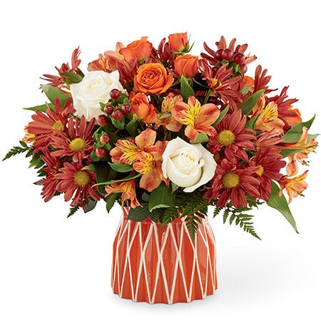 Fall flower arrangement with white and rose roses, red alstroemeria and maroon daisies