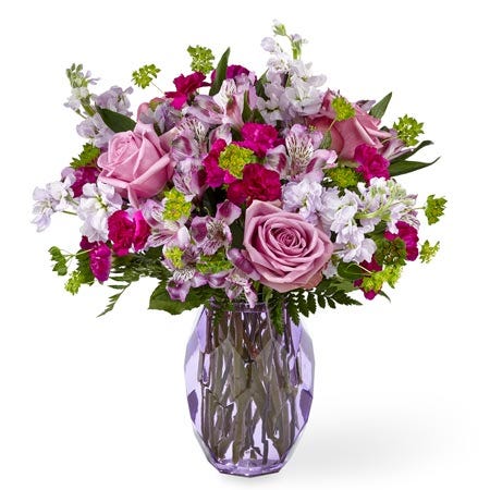 Lavender rose and alstroemeria flowers bouquet with lavender stock in purple vase