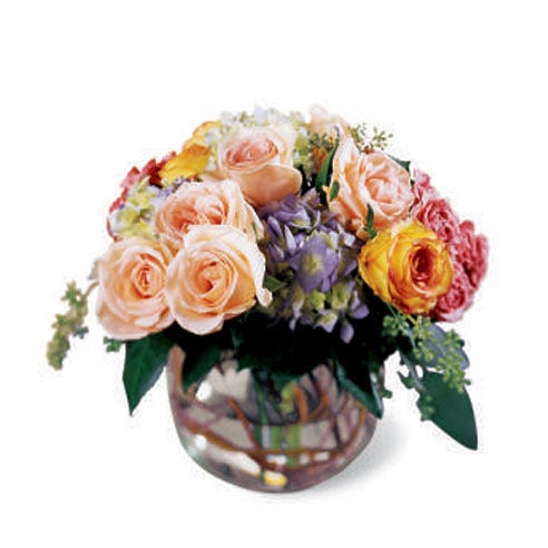 Peach roses, purple hydrangea and mixed flowers in a circle vase