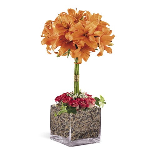 Orange lily flower topiary arrangement with square glass vase and pink roses