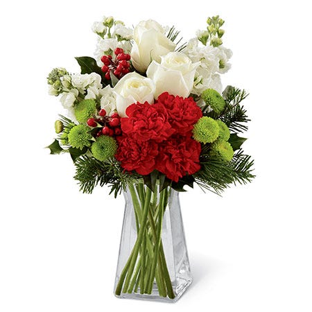 White roses, red carnations, and green poms Christmas flowers bouquet in a vase