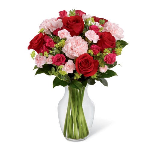 Red roses and pink carnations in a glass vase