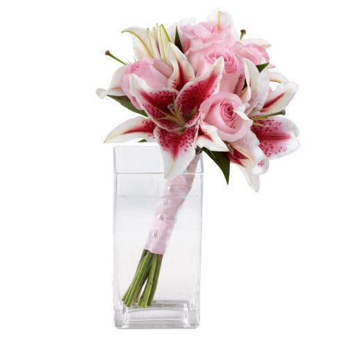 Handheld stargazer lily and light pink roses wedding bouquet wrapped with ribbon