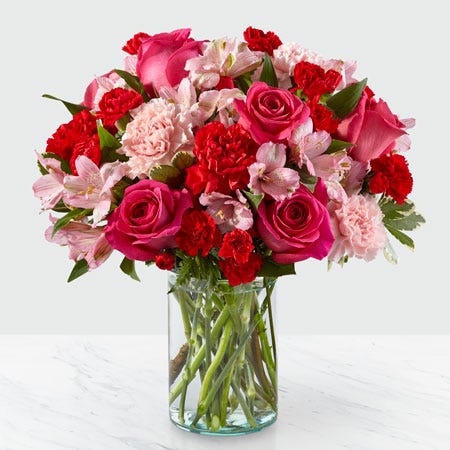 Hot pink roses, light pink carnations and hot pink carnations mixed spring bouquet
