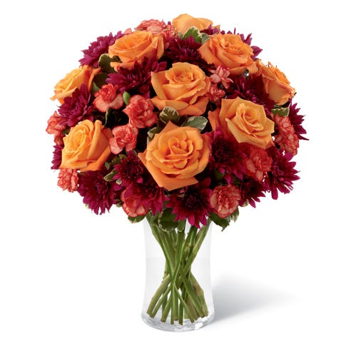 Orange roses and red mini carnations in Fall bouquet