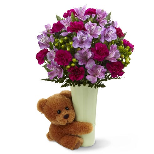 Green ceramic vase with a 6 inch bear hugging it and a combination of light lavender alstroemeria, magenta miniature carnations and light purple Peruvian lilies