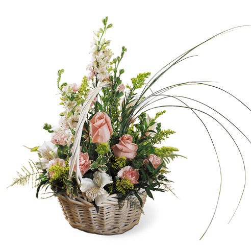 Peach roses and pink flowers delivered in a basket