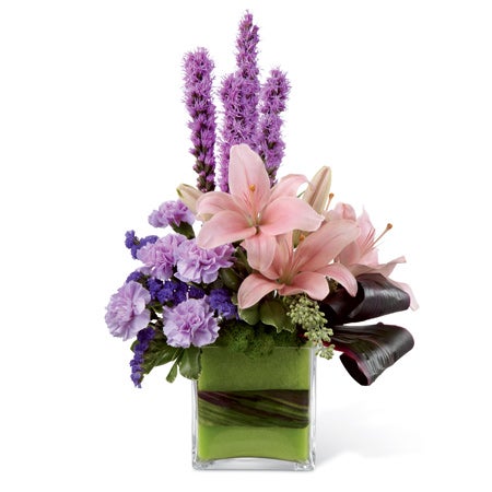 Modern flower arrangement with purple lilies, purple carnations, and purple statice
