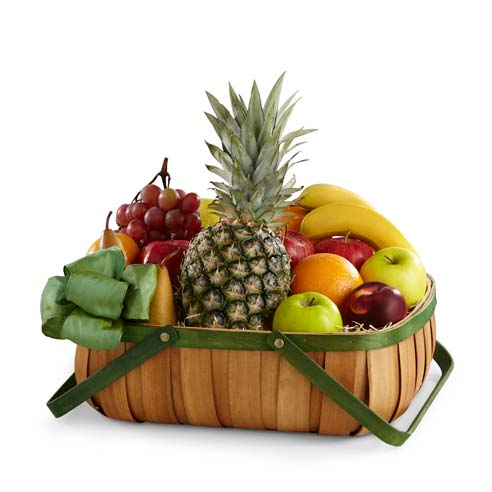 Assorted fruits on a green rimmed woven basket with green decorative ribbons