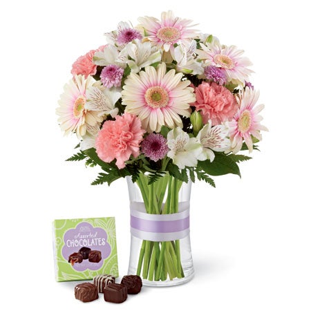 A Bouquet of Palest White-Pink Gerbera Daisies, Bi-Colored Pink & White Peruvian Lilies, Light-Pink Carnations, Lavender Mums and Alstroemeria in a Keepsake Tell Glass Vase with Lavender Ribbon and Small Box Of Chocolate