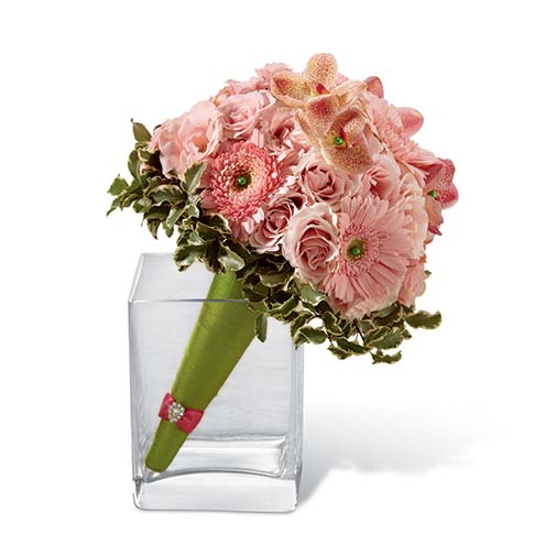 Pink Mokara orchids, mini gerbera diaises, and spray roses accented with greens and arranged within a green cone