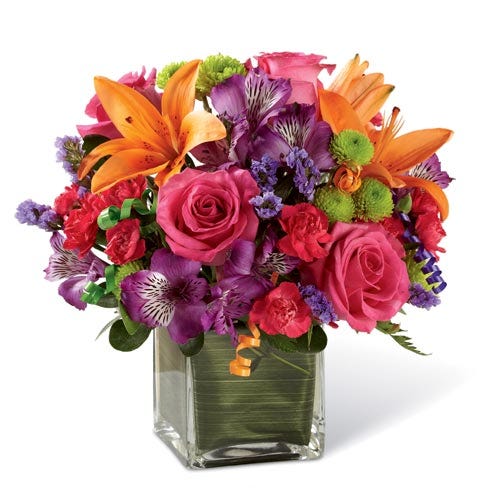 Pink roses, orange lilies, purple peruvian lily and a square glass vase