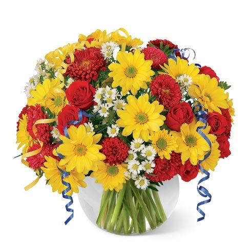 Red roses, matsumoto asters, yellow daisies in a circular glass vase
