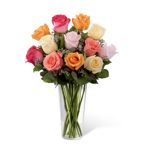 A Bouquet of Orange Roses, Coral Roses, Cream Roses, Light Pink Roses and Hot Pink Roses in a Clear Glass Vase