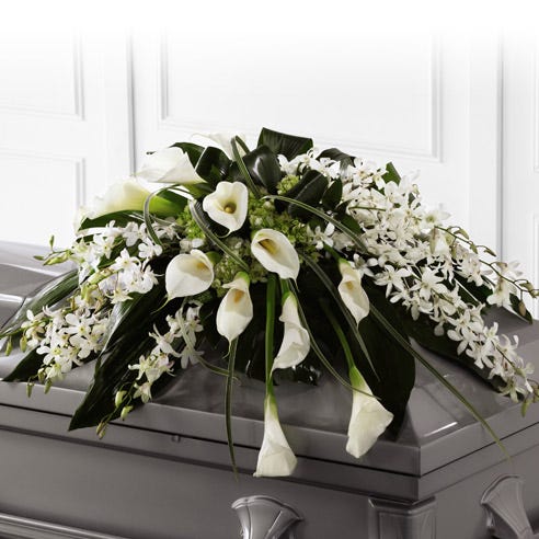 White orchids and calla lilies delivered by a florist