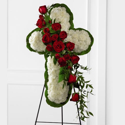 Cross shaped standing spray with red roses and white carnations