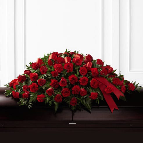 Red roses and red carnations in a casket spray