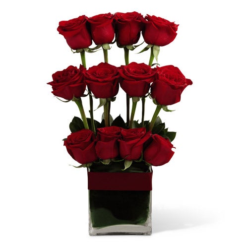 A Bouquet of  Dozen Red Roses and Tropical Greenery in a Modern Square Vase with Card Message and Decorative Bow