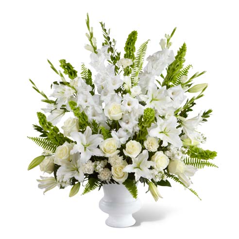 Beautiful white roses, bells of ireland and oriental lilies in sympathy arrangement 