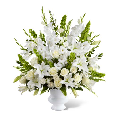 Beautiful white roses, bells of ireland and oriental lilies in sympathy arrangement