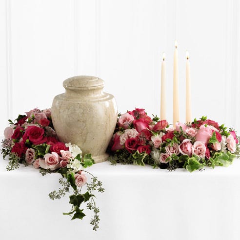 Remembrance arrangement with light pink roses and spray roses