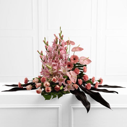 Pink gladiolus and rose sympathy flower arrangement with oriental lilies and daisies