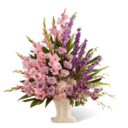 Lavender roses, pink gladiolus and purple orchids in sympathy vase arrangement