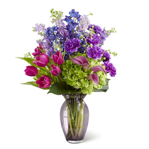 Purple carnations, purple roses, purple calla lilies, and purple tulips purple flower arrangement