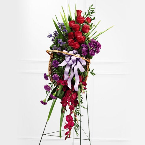 funeral spray with purple and red flowers
