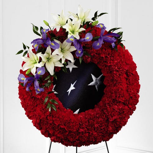 Patriotic Veteran standing spray American flag funeral flowers
